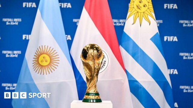 FIFA World Cup trophy in front of Uruguay, Argentina and Paraguay flags