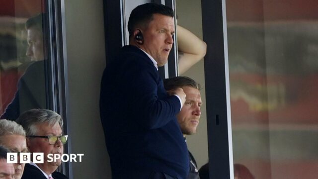 Gary Caldwell pictured watching from the stands as Exeter play Stockport
