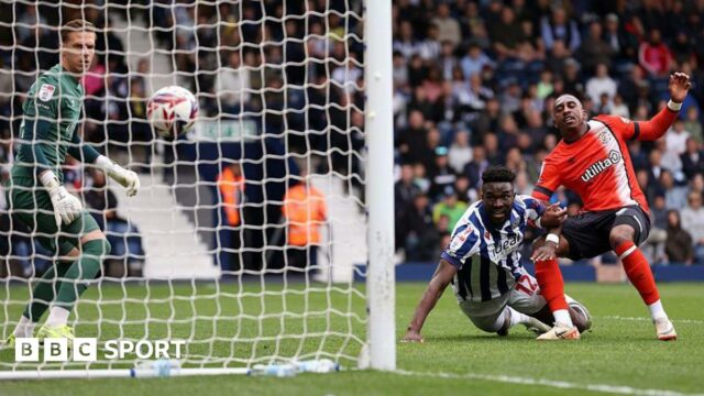 West Bromwich Albion's Daryl Dike hits the ground as he watches his header go into the goal against Luton Town