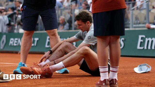 Ugo Humbert sits on the court after falling