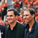 Rafael Nadal carries his son Rafael junior at the end of his French Open farewell ceremony
