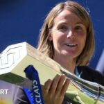 Chelsea manager Sonia Bompastor holds the WSL trophy