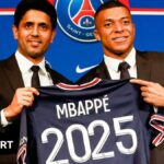 Kylian Mbappe holds up a PSG shirt with 2025 on the back