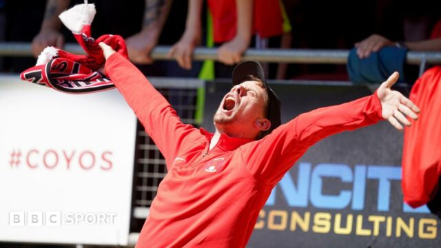 A Leyton Orient fan celebrates in the crowd