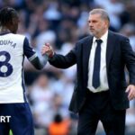 Yves Bissouma (left) shakes hands with Tottenham manager Ange Postecoglou