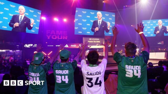 Saudi Arabia fans wave as Gianni Infantino makes a speech