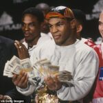 Tyson, ktorý stojí vedľa promotéra Don King, bliká trochu peňazí pre médiá