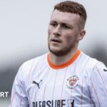 Sonny Carey wearing Blackpool's white-shirt away kit against Northampton Town