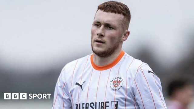 Sonny Carey wearing Blackpool's white-shirt away kit against Northampton Town