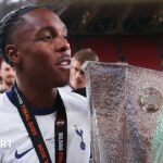 Mathys Tel holding the Europa League trophy