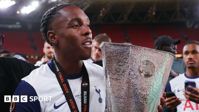 Mathys Tel holding the Europa League trophy