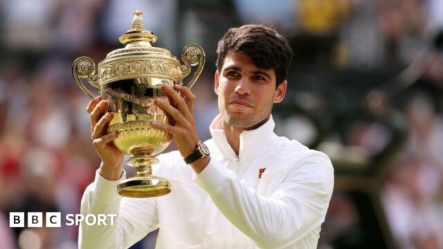 Carlos Alcaraz holds the Wimbledon men's singles trophy