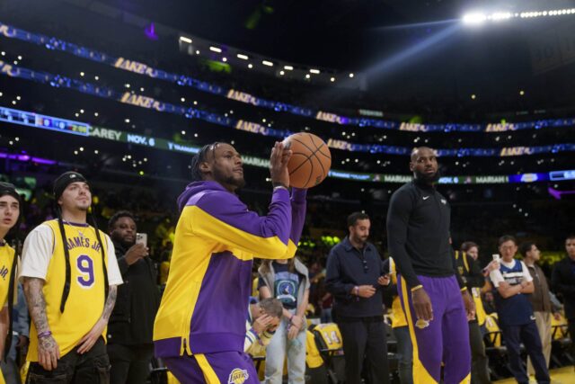 Los Angeles Lakers strážca Bronny James vľavo a postúpil LeBrona Jamesa pred basketbalovou hrou NBA proti Minnesote Timberwolves 22. októbra 2024 v Los Angeles.