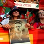 Fans of Portugal hold up a poster as a tribute following the death of Diogo Jota