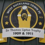 An image of West Auckland Town's crest which features the Sir Thomas Lipton Trophy 1909 & 1911.