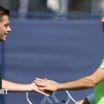 Neal Skupski and Joe Salisbury high-five after a point