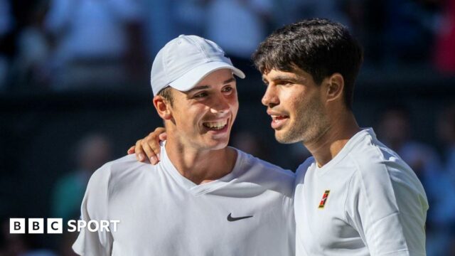 Oliver Tarvet is embraced by Carlos Alcaraz after their Wimbledon match