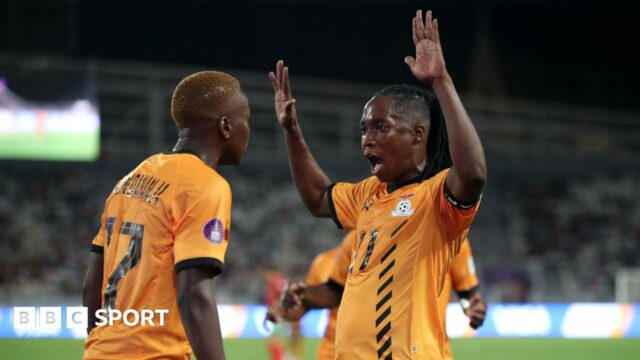 Zambia captain Barbra Banda raises both hands in the air as she celebrates a goal with team-mate Racheal Kundananji