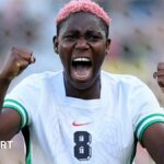 Asisat Oshoala celebrates while playing for Nigeria