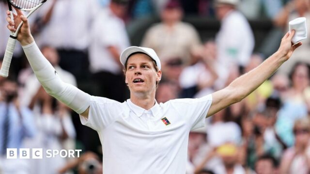 Jannik Sinner crouches to the ground after securing his first Wimbledon title