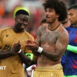 Marc Guehi and Chris Richards applaud the Crystal Palace fans