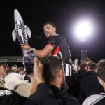 Reece Staunton is carried by fans holding an inflatable fish