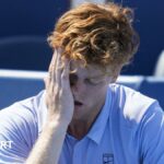 Jannik Sinner holds his head in his hand after retiring with illness from the Cincinnati Open final against Carlos Alcaraz
