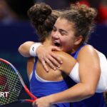 Jasmine Paolini and Sara Errani embrace after beating Ukraine in decisive Billie Jean King Cup doubles match
