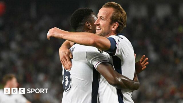 Harry Kane (R) celebrates with Marc Guehi