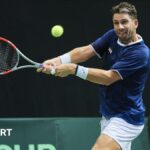 Cameron Norrie playing tennis for Great Britain against Poland's Tomasz Berkieta in Davis Cup in Gdynia, Poland