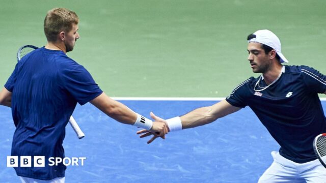 Julian Cash and Lloyd Glasspool shake hands during Davis Cup doubles match against Poland