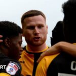 Newport County players celebrate scoring against Gillingham