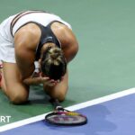 Aryna Sabalenka falls to the court after the 2025 US Open final