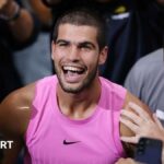 Carlos Alcaraz smiles after winning the US Open