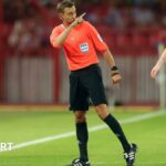 Referee Clement Turpin points to the stands during England's World Cup qualifier with Serbia in Belgrade