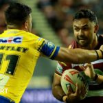 Wigan's Bevan French looks to fend off a tackle against Leeds