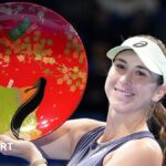 Belinda Bencic of Switzerland poses with the trophy