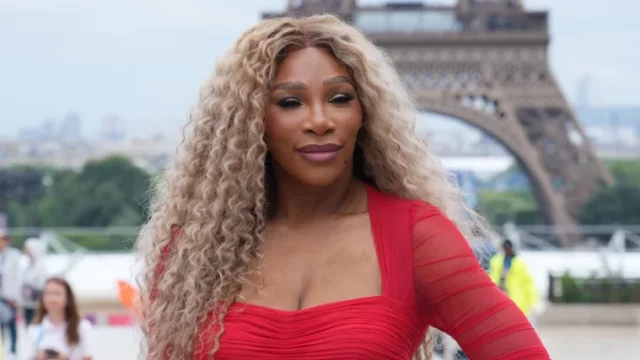 Serena Williams' daughter photobombs her as she poses in bold red dress image