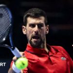 Novak Djokovic hits a return at the Six Kings Slam exhibition event