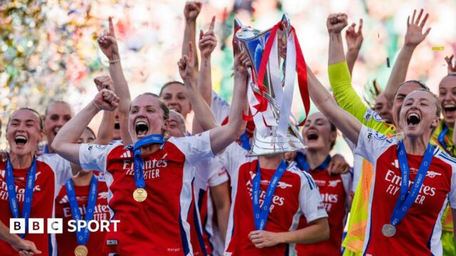 Arsenal players lift the Champions League trophy