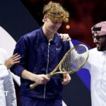 Jannik Sinner with Yasir Al-Rumayyan and Turki Al-Sheikh after winning the Six Kings Slam