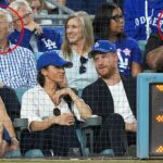 Princ Harry a Meghan Markle sedeli pred Sandy Koufax, zakrúžkovali vľavo a Magic Johnson, zakrúžkovali vpravo