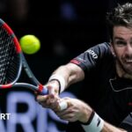 Cameron Norrie hits a backhand