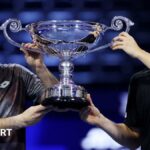 Julian Cash and Lloyd Glasspool are awarded their trophy for finishing as the year-end men's doubles world number ones