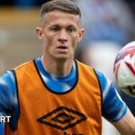 Jonathan Hogg warms up before a match for Huddersfield Town