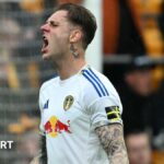 Wearing a white Leeds United shirt, Joe Rodon shouts