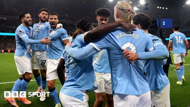 Manchester City players celebrate scoring against Liverpool together 