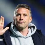 A close-up of former Middlesbrough boss Rob Edwards waving