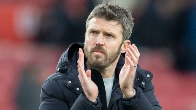 Steve Holland v čiernom kabáte