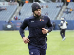 Fanúšikovia NFL reagujú, keď Caleb Williams prichádza v čiernom oblečení s charakteristickým matcha a káblovými slúchadlami na hru s divokou kartou Bears logo pochodového šialenstva